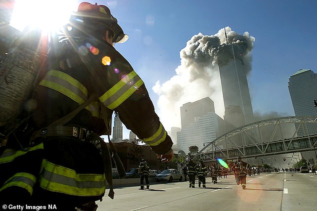 Researchers compared 10,786 firefighters who worked at the WTC site to 8,813 firefighters who didn't work at the site and found the WTC firefighters were 13% more likely of being diagnosed with cancer than their colleagues. Pictured: Firefighters walk towards one of the tower at the World Trade Center before it collapsed on 9/11